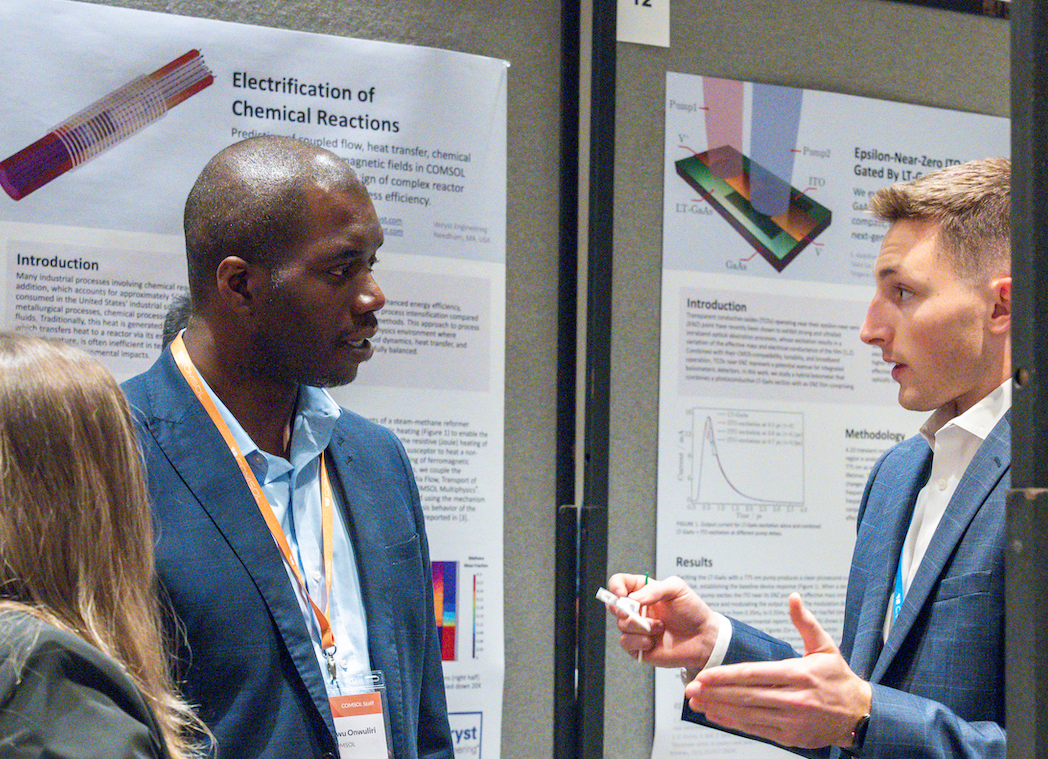 A conference attendee discusses their work during the poster session.